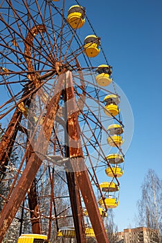 The thrown wheel a review against the blue sky in amusement park in Pripyat after the Chernobyl accident