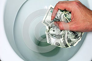 Throws money bills in the toilet