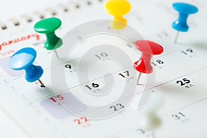 Thumb tack pin on calendar