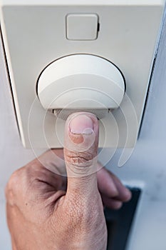 Thumb is turning on a light switch.