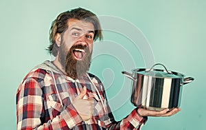 Thumb up. professional cook. bearded man hold kitchen pan. brutal hipster cooking with saucepan. housekeep husband cook