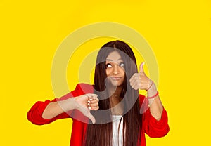 Thumb up or thumb down. Skeptical thinking woman judging deciding how to rate a situation. Is it good like or bad dislike concept