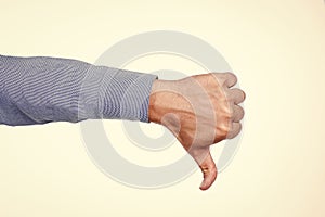 Thumbs down. dislike or unlike gesture. denote something bad. male hand with thumb down.