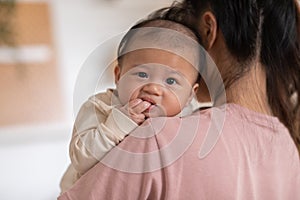 Thumbs or fingers sucking in baby newborn habit for calm and relax. Asian infant baby open mouth and putting fingers in to sucking
