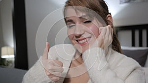 Thumbs Up by Casually Sitting Woman, Close up