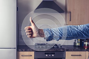 Thumbs up in clean and tidy kitchen