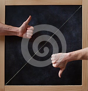 Thumbs up and down on blackboard