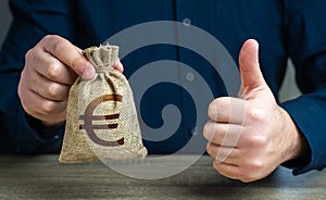 Thumbs up and euro money bag. The man approves the deal or loan.