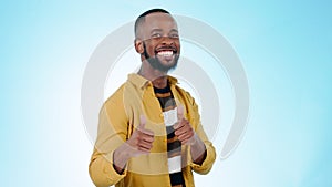 Thumbs up, face and man wink in studio for success, winning deal and achievement on blue background. Portrait, happy