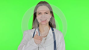 Thumbs Up by Female Doctor on Green Background