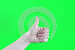 Thumbs up female hands with chroma key synthesis Hand showing LIKE against green blackboard. Education concept