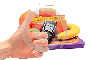 Thumbs up, glucometer and healthy ingredients with tape measure