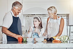 Thumbs up, grandparents or child cooking in kitchen as a happy family in a house with healthy vegetables at dinner