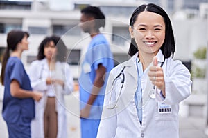 Thumbs up, leadership and portrait of a female doctor standing outdoor of the hospital. Happy, smile and professional