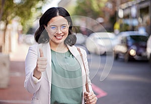 Thumbs up, portrait and business woman in the city, street or professional worker with success, agreement or thank you