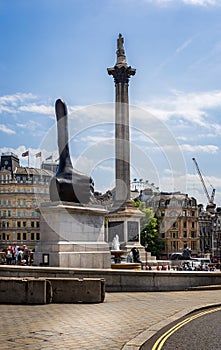 Thumbs up statue in front of Nelson Column in Trafalgar Square, London, UK