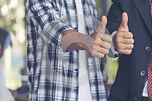 Thumbs up team hand satisfaction job with positive happy good sign. Close up business people partner hand Positive idea good sign
