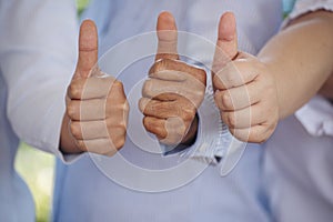 Thumbs up team hand satisfaction job with positive happy good sign. Close up business people partner hand Positive idea good sign