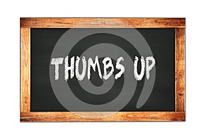 THUMBS  UP text written on wooden frame school blackboard