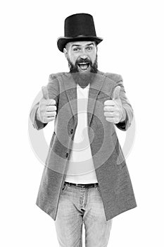 Thumbs up to retro. Bearded man wearing cylinder hat in retro style. Caucasian guy showing thumbs ups in retro tophat