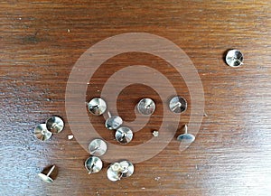 Thumbtack placed on brown wooden background