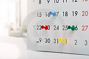 Thumbtacks in calendar - concept of busy schedule