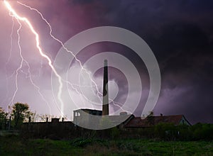 Thunder, lightning and storm over abandoned factory in summer