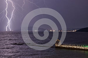 Thunder-storm and lightning on the sea photo