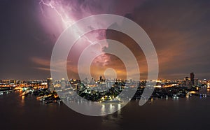 Thunder storm lightning strike over building area in Bangkok