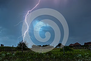 Thunderbolt of lightning strikes down in a rural landscape