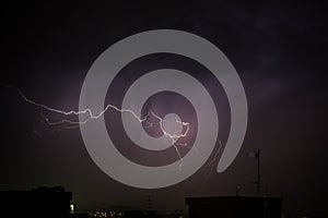 Thunderbolt over the city during a storm at night