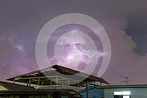 Thunderbolt over the house and dark stormy sky on the background