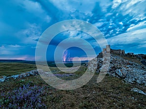 Thunderbolts,lightning on a cloudy evening blue sky over old Enisala stronghold,citadel