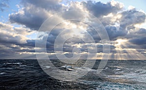 Thunderclouds and rain clouds over the sea horizon and the surface of the Pacific Ocean.