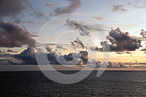 Thunderclouds and rain clouds over the sea horizon and the surface of the Pacific Ocean.