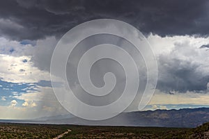 Thunderhead cloud produces rain shower over semi-desert grassland prairie