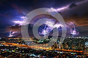 Thunderstorm clouds with lightning at night in Seoul, South Korea photo