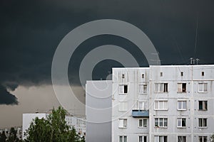 Thunderstorm, dark sky, white building with windows