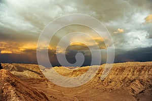 Thunderstorm developing over sand dune in Valle De La Luna in the Atacama Desert near San Pedro de Atacama, Chile