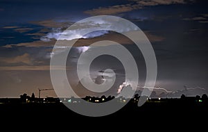 Thunderstorm is illuminated by flashes of lightning