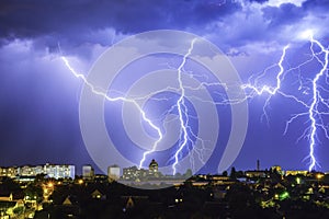 Thunderstorm with lightning above the night city