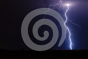 Thunderstorm lightning bolt strike from a storm at night