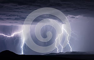 Thunderstorm lightning bolts striking a mountain