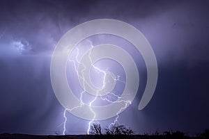 Thunderstorm and lightning bolts striking at night