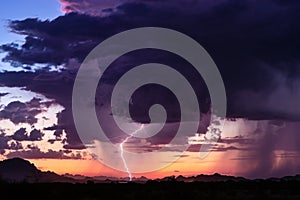 Thunderstorm lightning strike at sunset