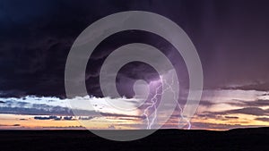 Thunderstorm lightning strike at sunset