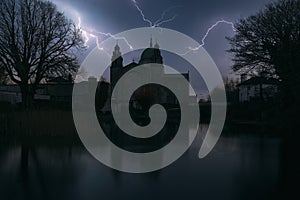 Thunderstorm and lightning strikes over Galway cathedral by Corrib River in Ireland