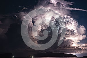 Thunderstorm over island at night