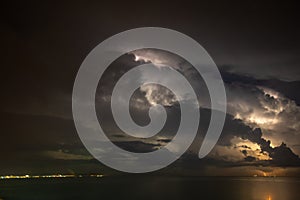 Thunderstorm over the sea, lightning beats the water