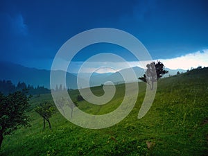 Thunderstorm sky over green alpine hills in carpathian mountains